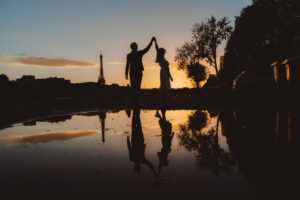 エッフェル塔と夕暮れの光を受けるふたりのシルエット