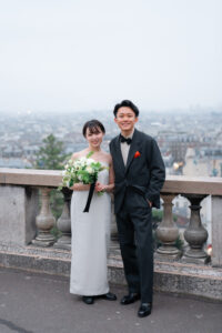 パリ モンマルトル 朝景色を背に立つふたりのポートレート